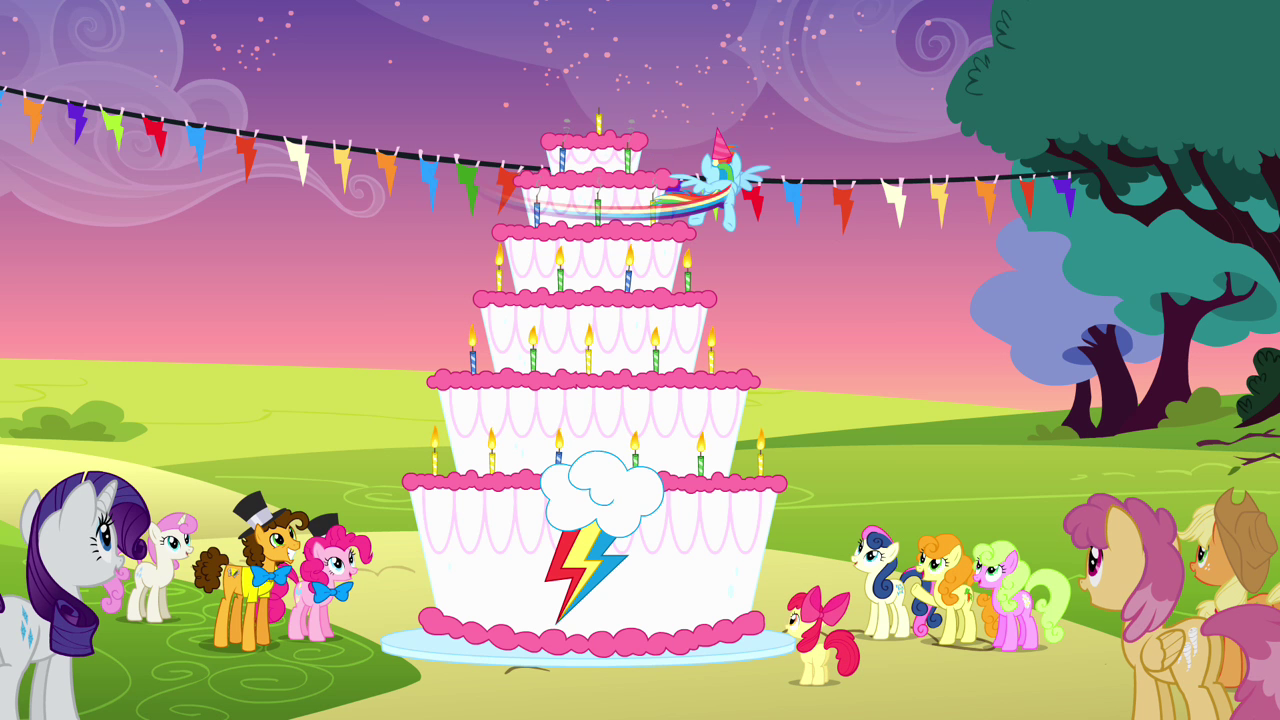 Rainbow_spinning_around_the_cake_to_blow